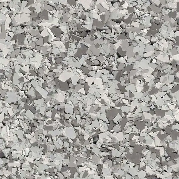 A detailed close-up of a grey terrazzo surface, showcasing small, irregularly shaped chips and a smooth, polished finish.
