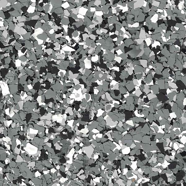 A close-up view of a textured surface, featuring an abstract pattern of black, white, and gray irregular shapes scattered randomly.