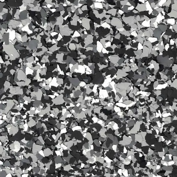 A close-up of a random gray, black, and white textured pattern resembling scattered stones or confetti on a flat surface.