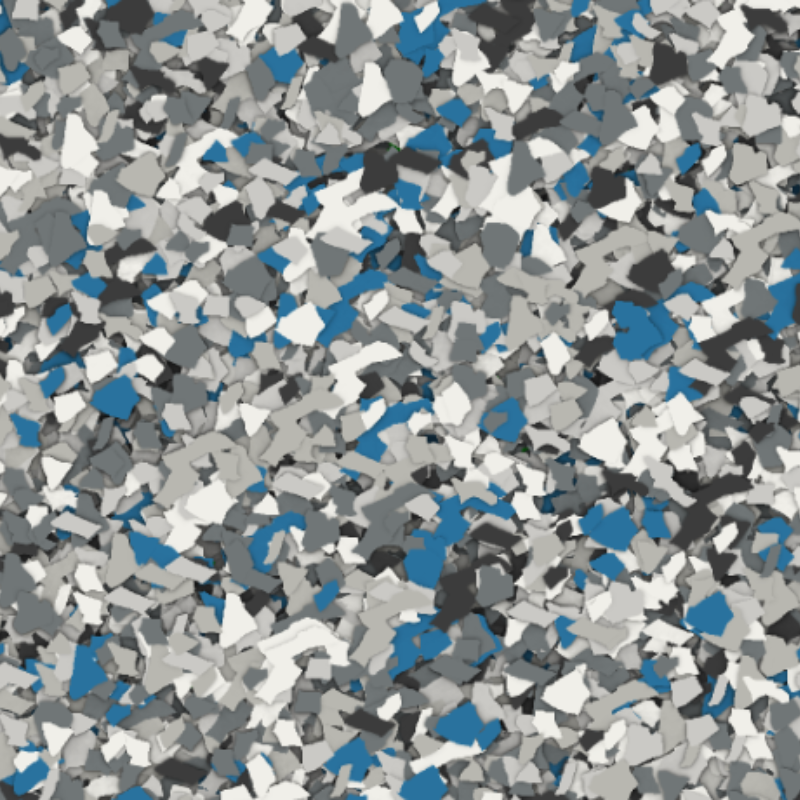 A close-up of colorful, irregularly-shaped flakes in blue, white, and gray tones, resembling a textured mosaic or artistic pattern.