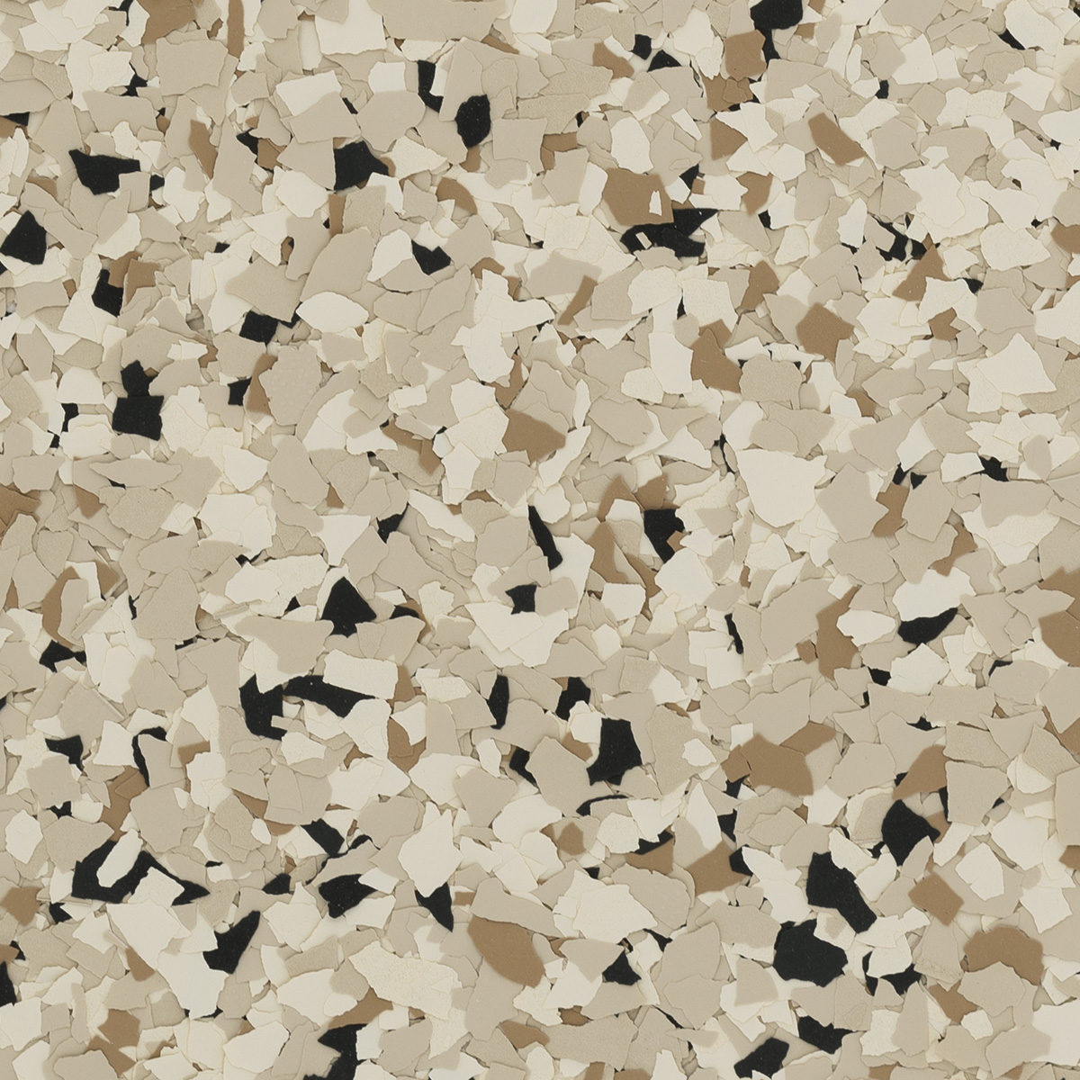 Surface covered with cream, beige, and black decorative flakes, resembling textured chips for flooring or wall applications. No recognizable landmarks or buildings visible.